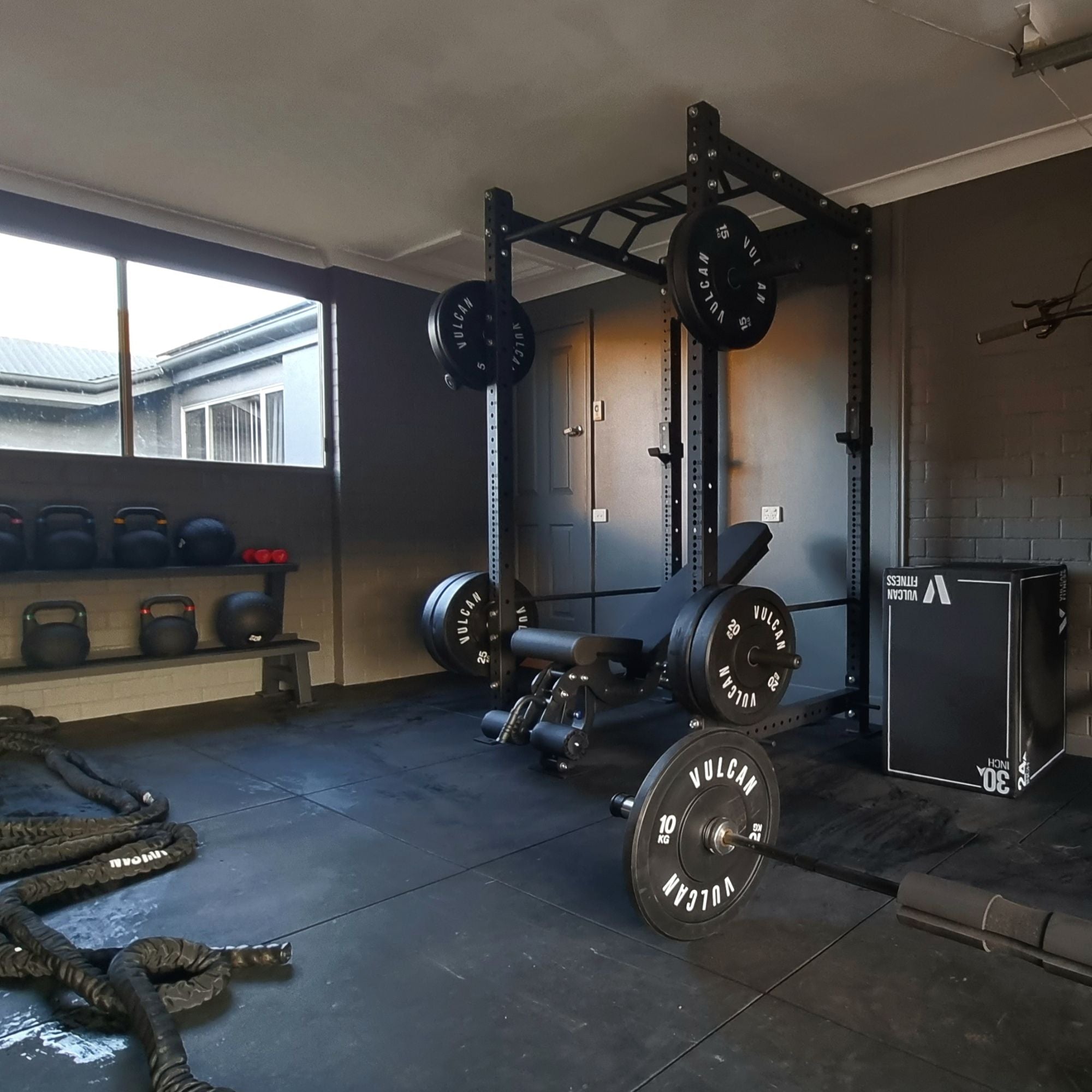 commercial power rack in home garage gym